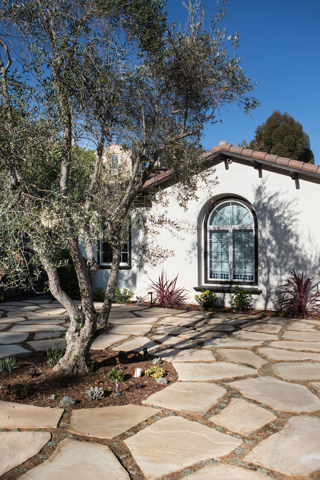 Inspiration for a large mediterranean one-storey stucco white exterior in San Diego with a hip roof.