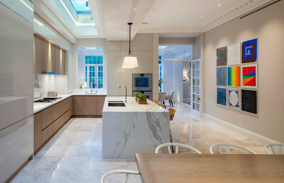 Inspiration for a large contemporary l-shaped eat-in kitchen in London with a double-bowl sink, flat-panel cabinets, stainless steel appliances, with island, white benchtop, medium wood cabinets, marble benchtops, marble floors and white floor.