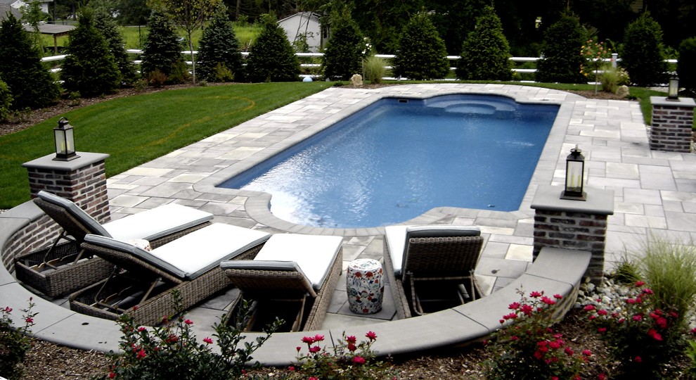 Example of a large transitional backyard rectangular pool design in New York