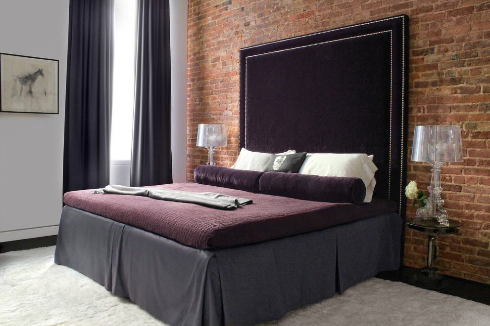 Contemporary bedroom in New York with white walls, dark hardwood floors and no fireplace.