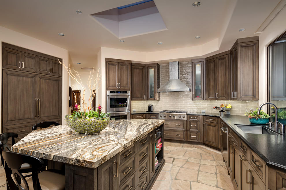 Design ideas for a large l-shaped eat-in kitchen in Phoenix with an undermount sink, recessed-panel cabinets, medium wood cabinets, granite benchtops, beige splashback, ceramic splashback, stainless steel appliances and with island.