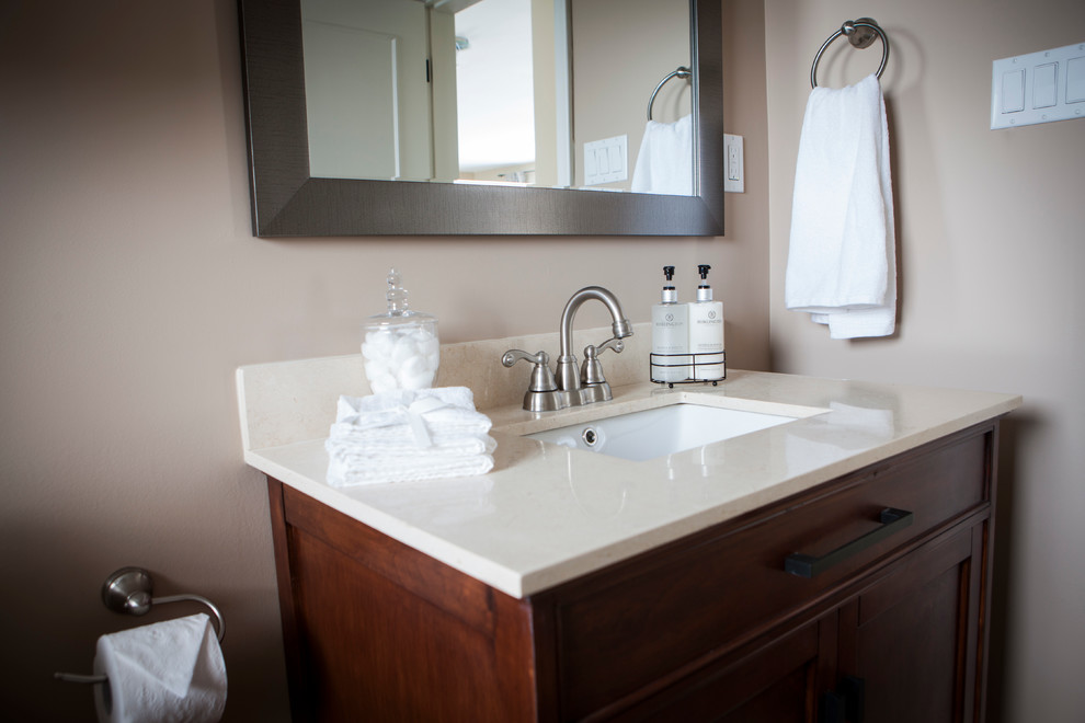 Example of a mid-sized transitional beige tile and porcelain tile ceramic tile alcove bathtub design with an undermount sink, shaker cabinets, medium tone wood cabinets, marble countertops, a one-piece toilet and beige walls