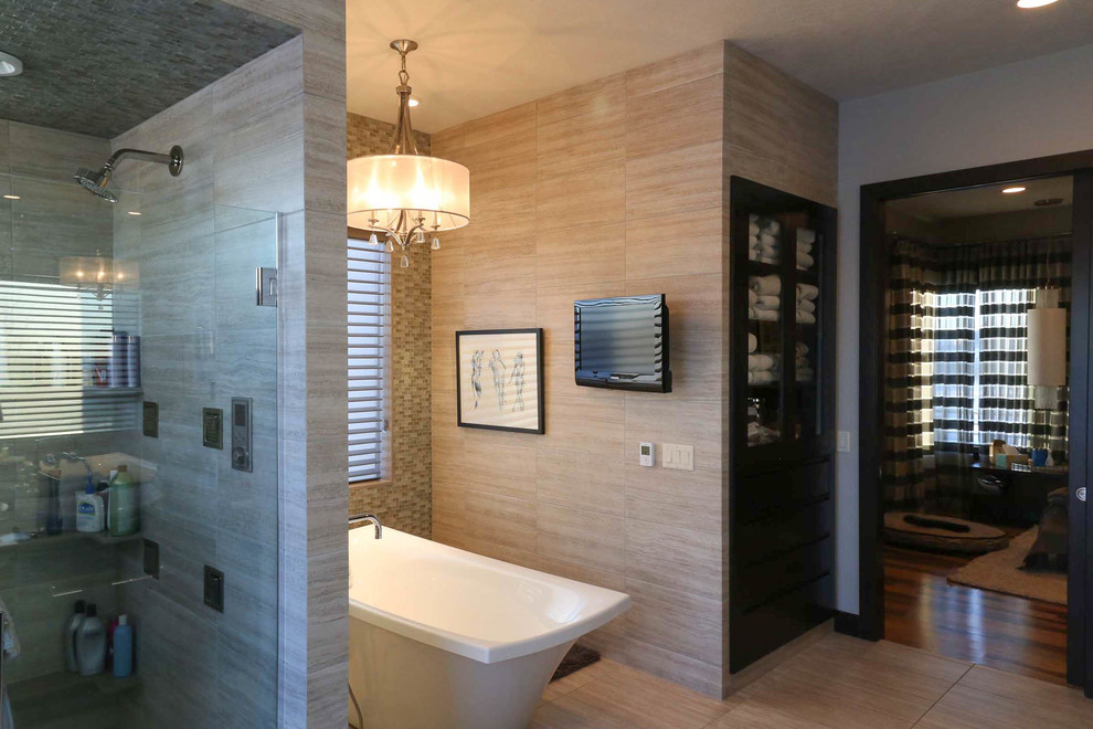 Large transitional master beige tile and porcelain tile porcelain tile and beige floor freestanding bathtub photo with shaker cabinets, black cabinets, a two-piece toilet, beige walls, a vessel sink, quartzite countertops, a hinged shower door and black countertops