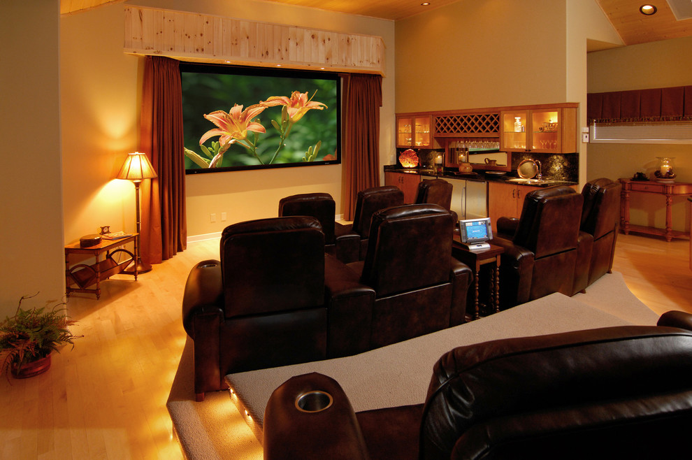 Inspiration for a mid-sized transitional open concept home theatre in Charlotte with beige walls, light hardwood floors, a wall-mounted tv and brown floor.