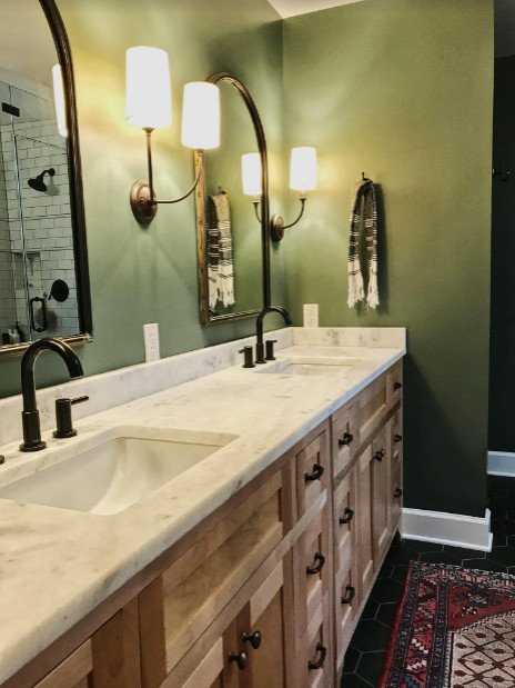 Freestanding bathtub - large transitional master porcelain tile, gray floor, double-sink and vaulted ceiling freestanding bathtub idea with shaker cabinets, light wood cabinets, a two-piece toilet, green walls, an undermount sink, marble countertops, a hinged shower door, white countertops and a built-in vanity