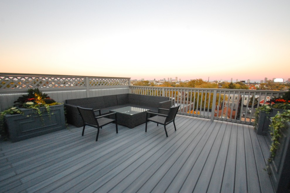 Inspiration for a large transitional rooftop outdoor kitchen deck remodel in Chicago with a pergola
