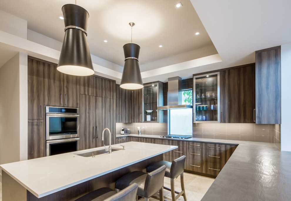 This is an example of an expansive contemporary u-shaped open plan kitchen in Miami with an undermount sink, flat-panel cabinets, grey cabinets, quartz benchtops, grey splashback, glass tile splashback, stainless steel appliances, marble floors, with island and beige floor.