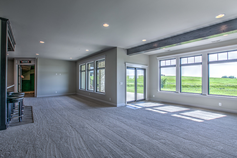 Inspiration for a large traditional open concept family room in Omaha with a game room, beige walls, carpet, no fireplace and a wall-mounted tv.