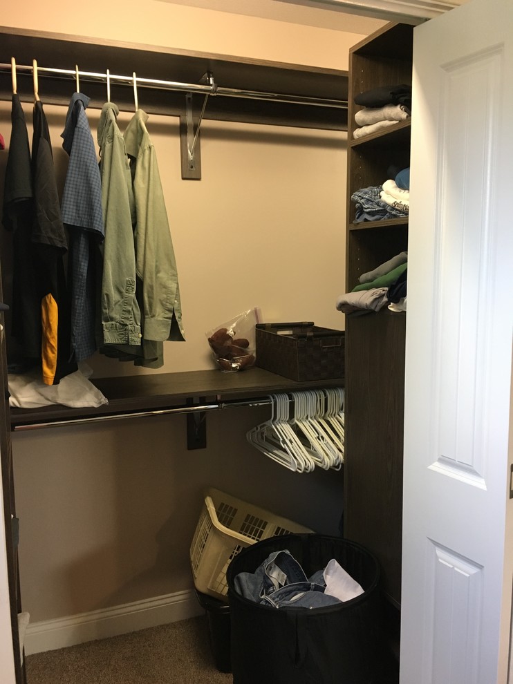 Small transitional gender-neutral carpeted reach-in closet photo with flat-panel cabinets and dark wood cabinets