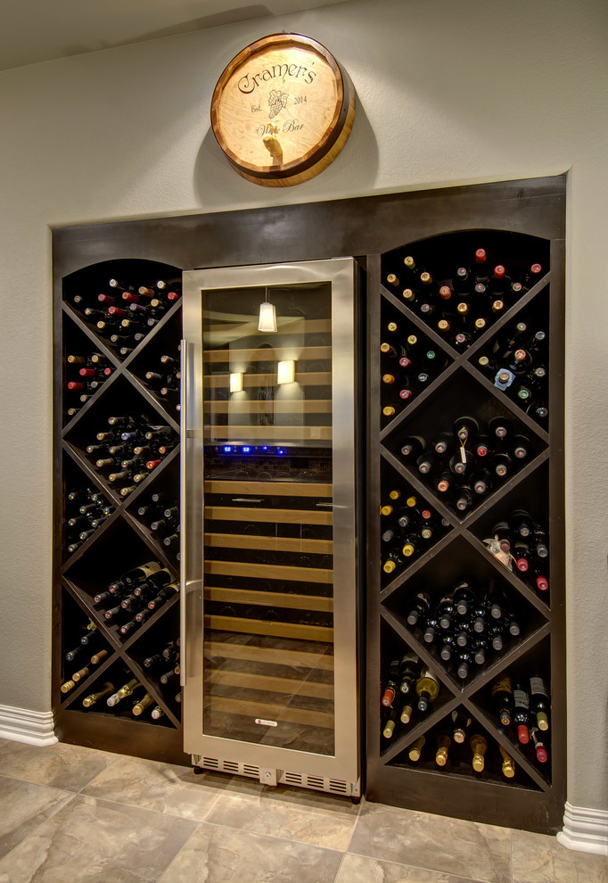 This is an example of a mid-sized transitional wine cellar in Denver with carpet and beige floor.