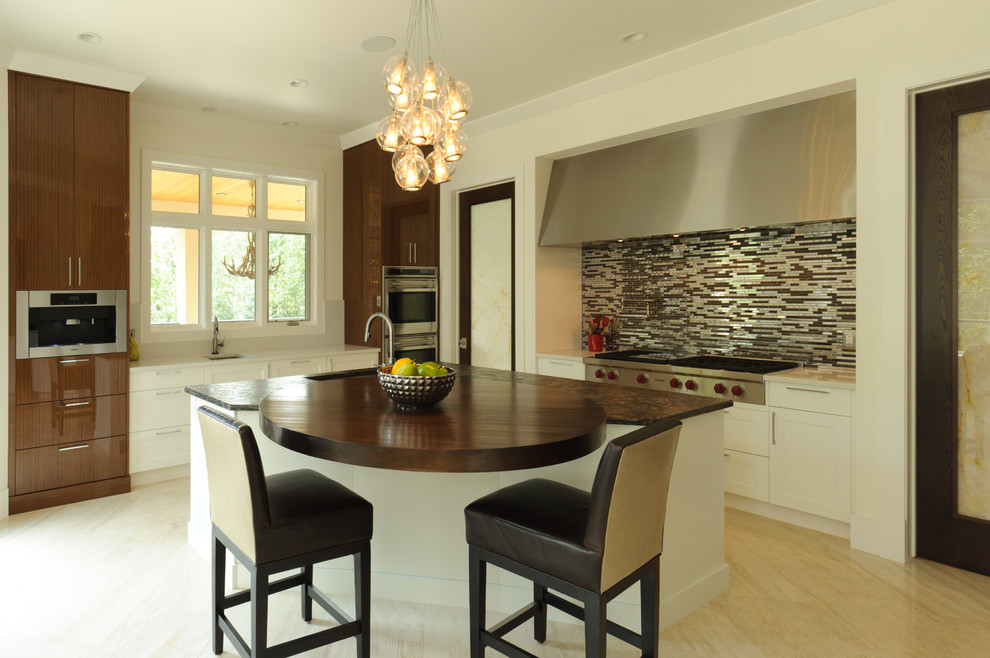 Eat-in kitchen - mid-sized transitional l-shaped porcelain tile eat-in kitchen idea in Calgary with an undermount sink, stainless steel appliances, an island, quartz countertops, multicolored backsplash and mosaic tile backsplash