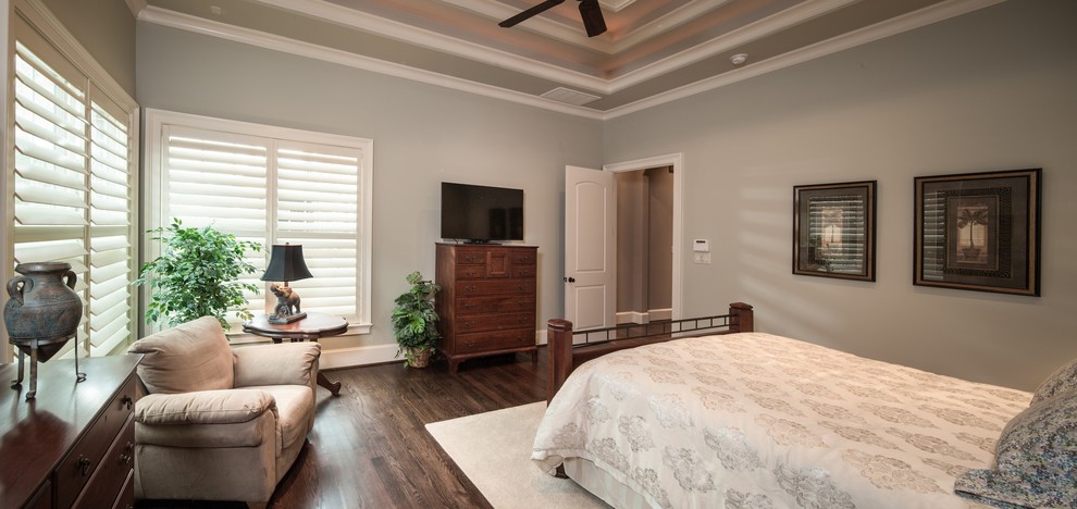 Mid-sized traditional master bedroom in Houston with blue walls and dark hardwood floors.