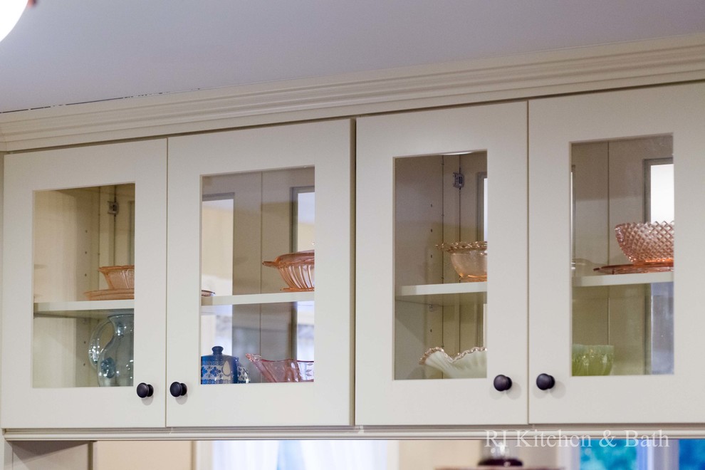 Example of a large transitional u-shaped light wood floor eat-in kitchen design in Providence with an undermount sink, shaker cabinets, beige cabinets, granite countertops, brown backsplash, porcelain backsplash, stainless steel appliances and an island