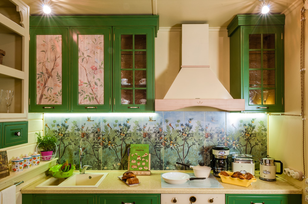Inspiration for a small eclectic single-wall eat-in kitchen in Moscow with raised-panel cabinets, green cabinets, solid surface benchtops, ceramic splashback, porcelain floors and white appliances.