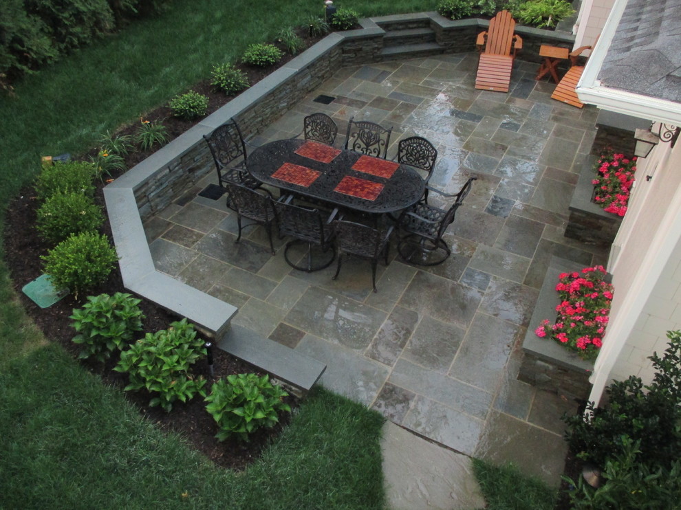 Mid-sized traditional backyard patio in New York with an outdoor kitchen, tile and no cover.