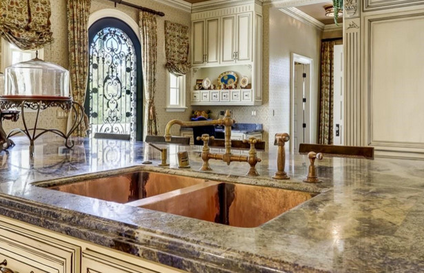 This is an example of an expansive traditional galley separate kitchen in Miami with an undermount sink, raised-panel cabinets, white cabinets, granite benchtops, red splashback, stone tile splashback, coloured appliances, terra-cotta floors and multiple islands.