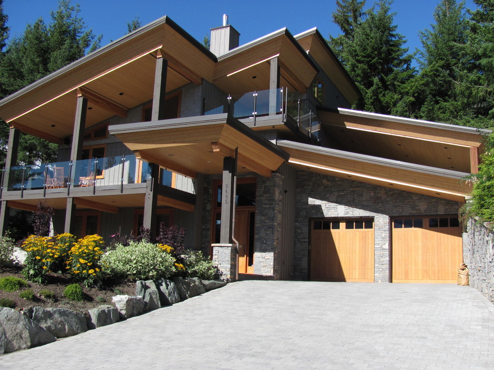Large mountain style two-story house exterior photo with a metal roof