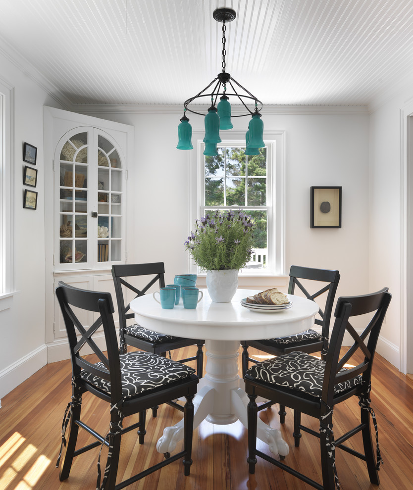 Design ideas for a beach style dining room in Providence with white walls and medium hardwood floors.