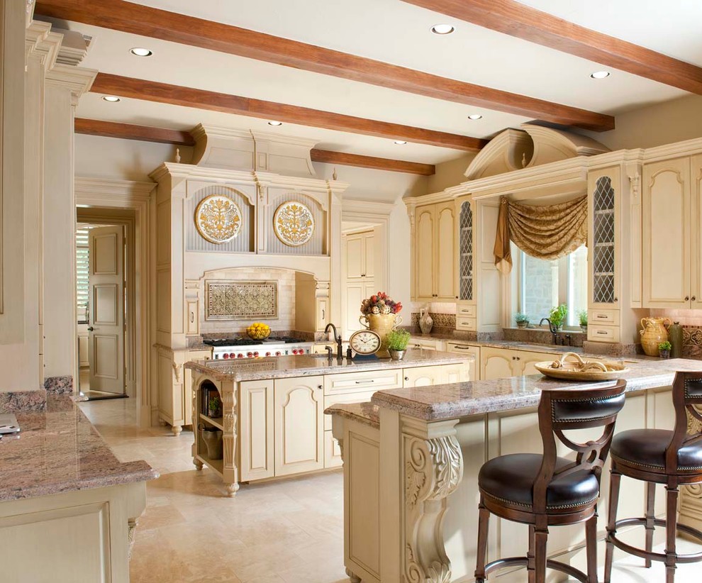 Mediterranean kitchen in Dallas with an undermount sink, raised-panel cabinets, beige cabinets and multi-coloured splashback.