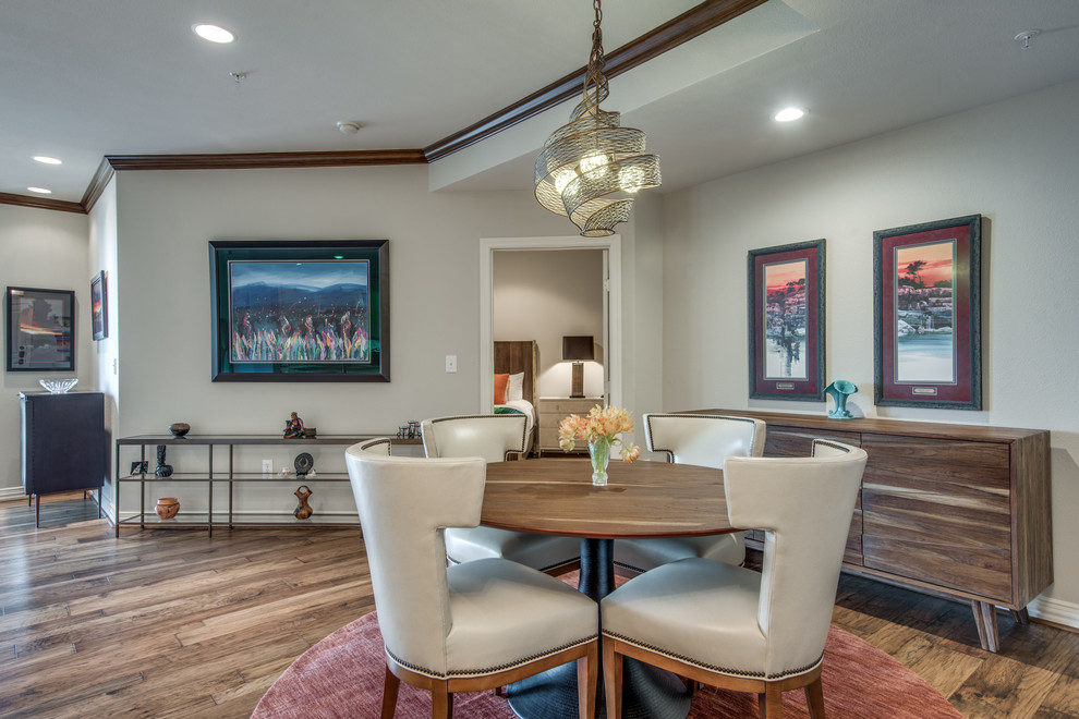This is an example of a small open plan dining in Dallas with beige walls and medium hardwood floors.