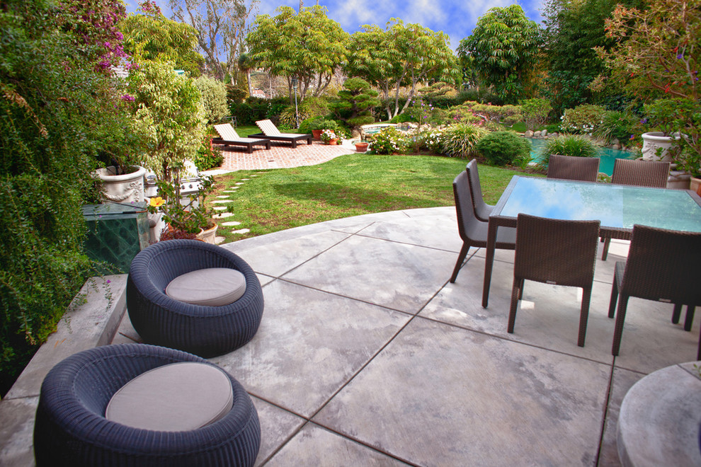 Transitional patio in Los Angeles with concrete slab and no cover.