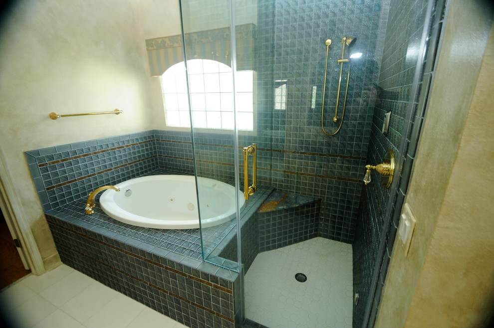 Inspiration for a large traditional master bathroom in Tampa with recessed-panel cabinets, yellow cabinets, a drop-in tub, an alcove shower, a two-piece toilet, brown tile, porcelain tile, yellow walls, porcelain floors, a vessel sink, marble benchtops, white floor and a hinged shower door.