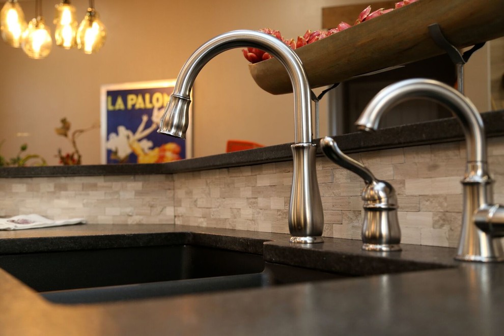 Example of a small transitional u-shaped light wood floor open concept kitchen design in Orange County with an undermount sink, louvered cabinets, white cabinets, solid surface countertops, beige backsplash, stone tile backsplash, stainless steel appliances and two islands