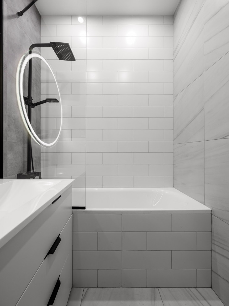 Example of a small trendy master white tile gray floor and single-sink bathroom design in Other with flat-panel cabinets, white cabinets, a wall-mount toilet, white walls, an integrated sink and a freestanding vanity