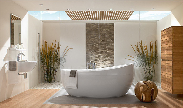 This is an example of a large modern master bathroom in Miami with a freestanding tub, an alcove shower, white walls, light hardwood floors, a wall-mount sink, brown floor and a hinged shower door.