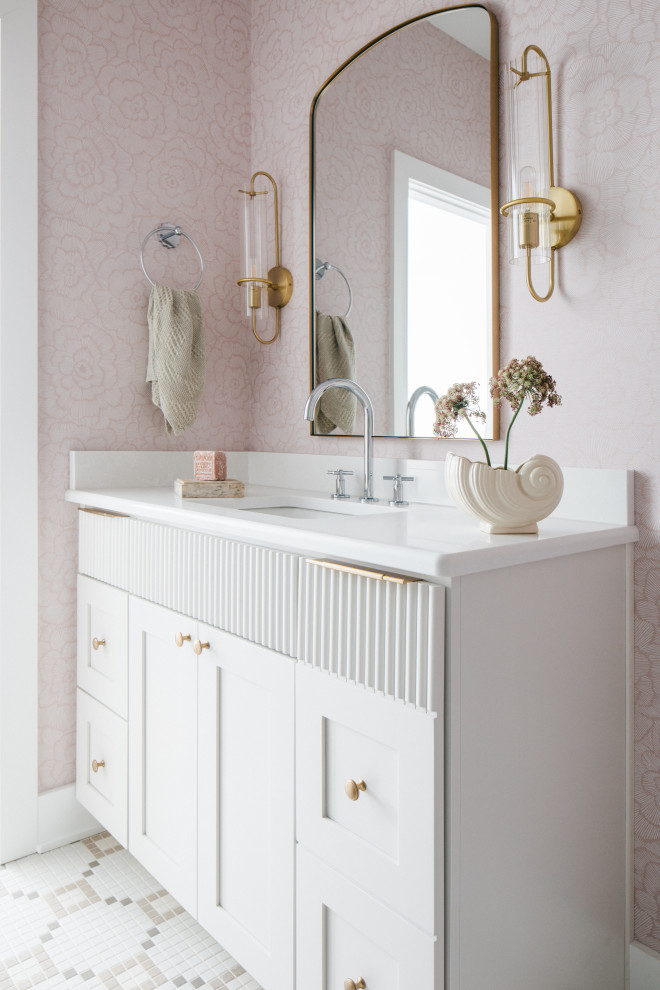 Photo of a traditional bathroom in Chicago with shaker cabinets, white cabinets, pink walls, mosaic tile flooring, a submerged sink, multi-coloured floors, white worktops, a single sink, a built in vanity unit and wallpapered walls.