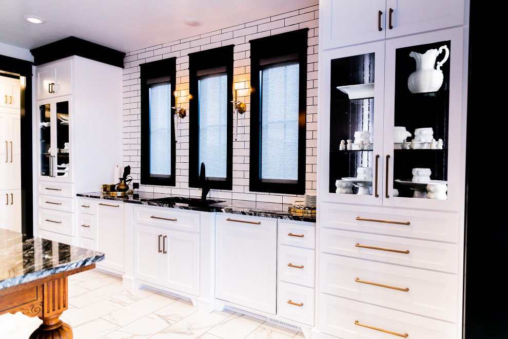 Inspiration for a modern kitchen in Other with a double-bowl sink, shaker cabinets, white cabinets, granite benchtops, white splashback, subway tile splashback, black appliances, porcelain floors, with island and white floor.