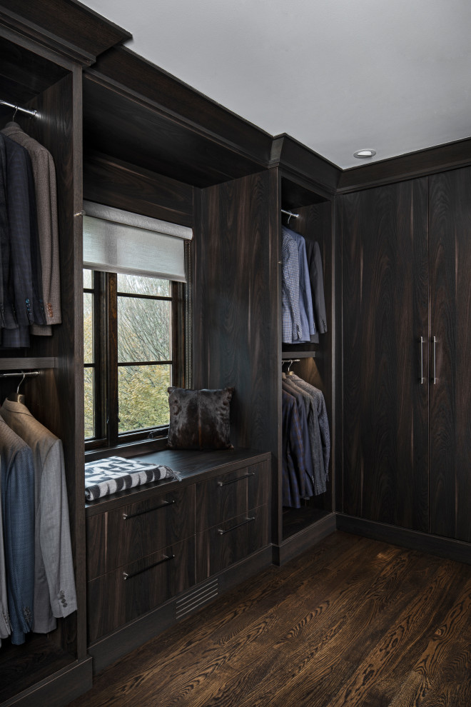 Large midcentury walk-in wardrobe in Detroit with flat-panel cabinets, dark wood cabinets, dark hardwood floors and brown floor.