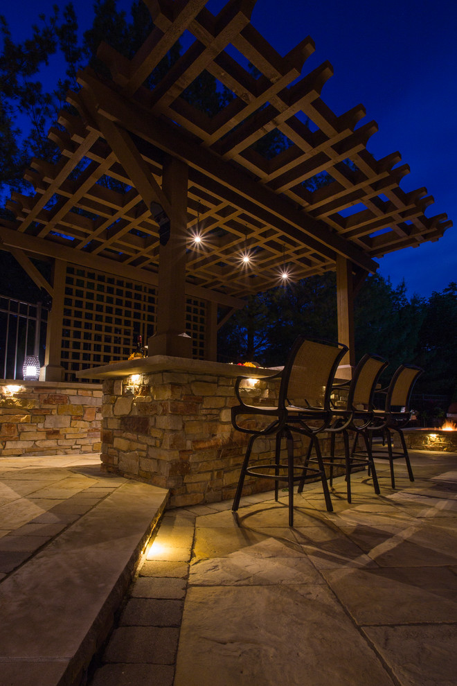 Large traditional backyard partial sun garden in Chicago with a fire feature and natural stone pavers for summer.