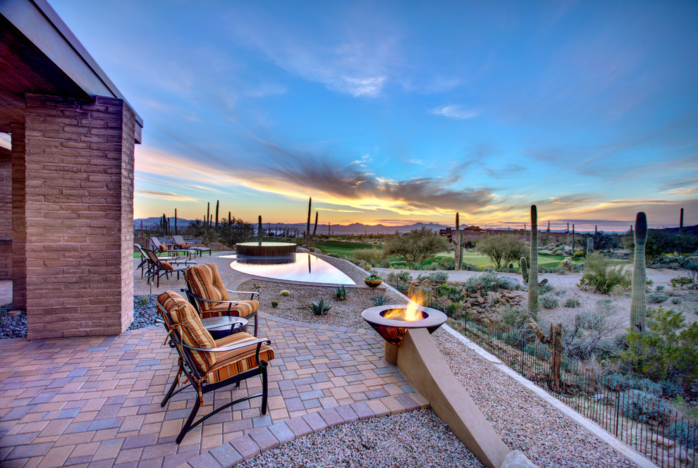 Inspiration for an expansive backyard patio in Phoenix with a fire feature, concrete pavers and no cover.
