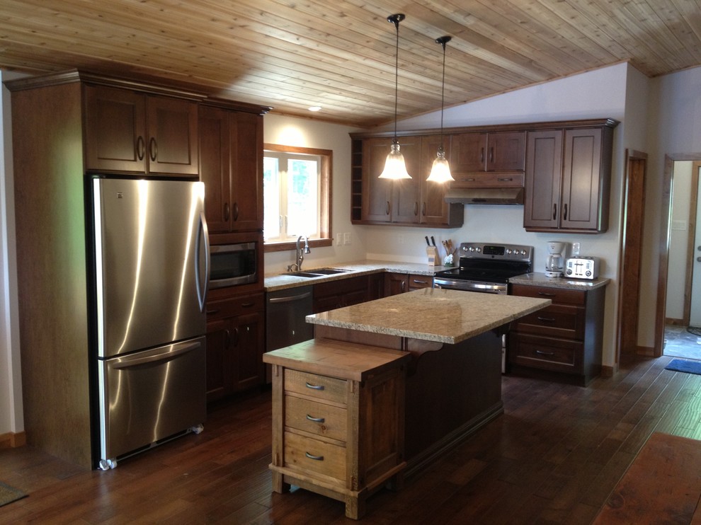Example of a mid-sized mountain style l-shaped dark wood floor kitchen pantry design in Toronto with a double-bowl sink, shaker cabinets, dark wood cabinets, granite countertops, stainless steel appliances and an island