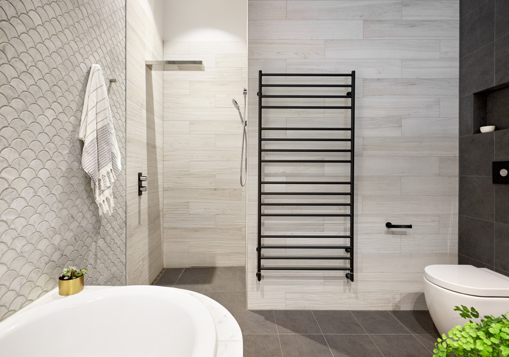 This is an example of a mid-sized contemporary master bathroom in Melbourne with glass-front cabinets, medium wood cabinets, a corner tub, an open shower, pebble tile, a vessel sink and laminate benchtops.