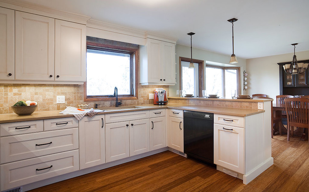 Large transitional u-shaped medium tone wood floor and brown floor eat-in kitchen photo with an undermount sink, recessed-panel cabinets, white cabinets, solid surface countertops, beige backsplash, ceramic backsplash, stainless steel appliances, a peninsula and gray countertops