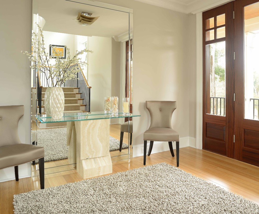 This is an example of a large modern foyer in Charleston with grey walls, bamboo floors, a medium wood front door and a single front door.
