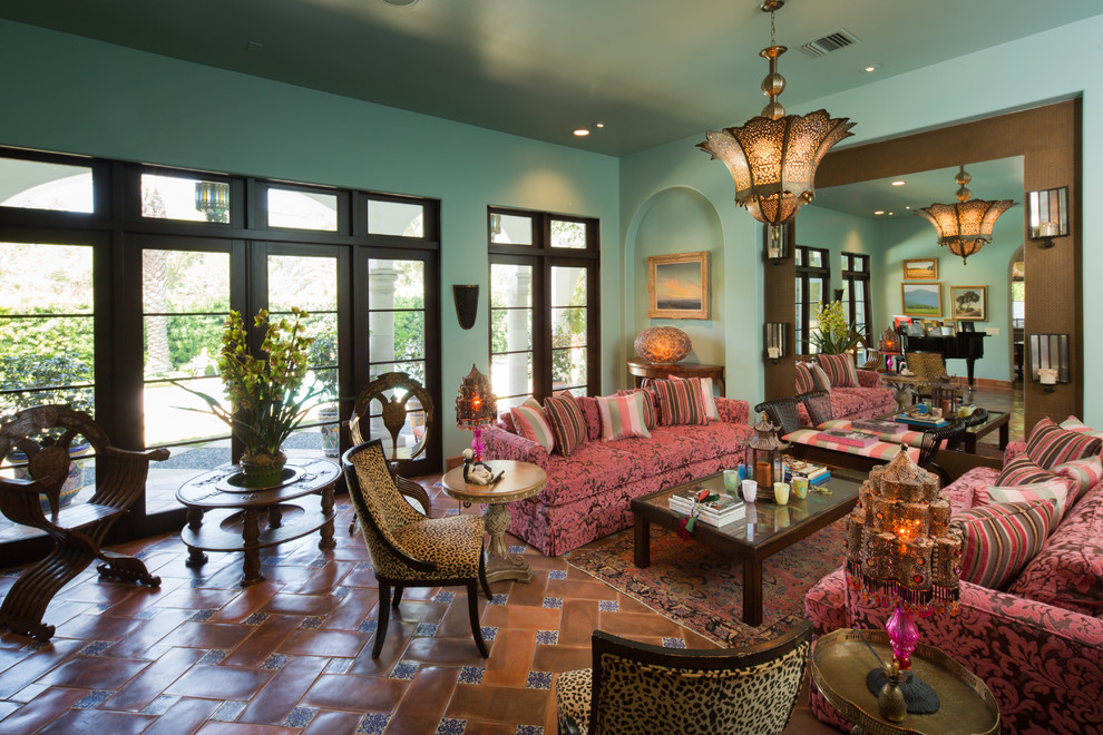 Inspiration for a large mediterranean enclosed living room in Houston with blue walls, no tv and terra-cotta floors.