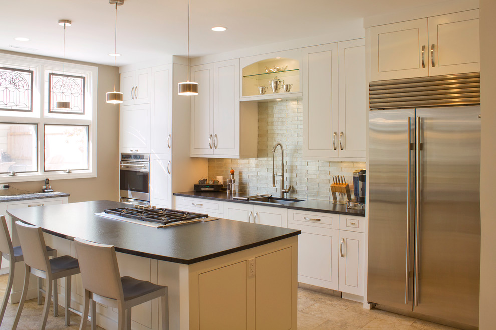 This is an example of a mid-sized transitional single-wall separate kitchen in Indianapolis with an undermount sink, beaded inset cabinets, white cabinets, quartz benchtops, beige splashback, porcelain splashback, stainless steel appliances, porcelain floors, with island and beige floor.