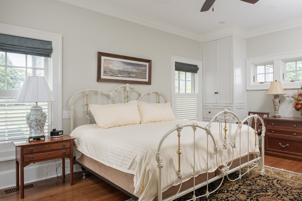 Design ideas for a large beach style guest bedroom in Bridgeport with beige walls and medium hardwood floors.