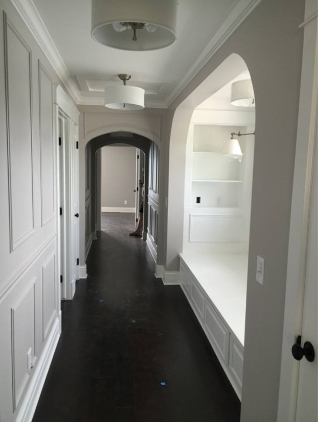 Hallway - mid-sized transitional dark wood floor and brown floor hallway idea with gray walls