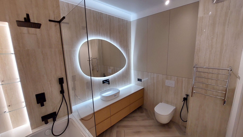 Photo of a medium sized modern bathroom in Other with beige cabinets, a claw-foot bath, a shower/bath combination, a wall mounted toilet, beige tiles, porcelain tiles, beige walls, porcelain flooring, a vessel sink, beige floors, white worktops and a single sink.