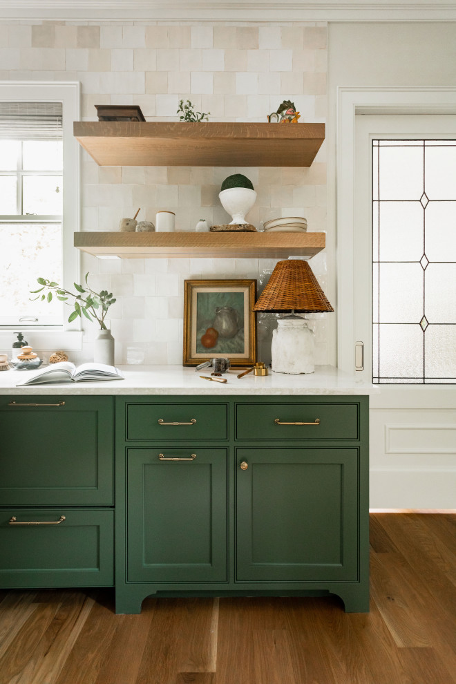 This is an example of an expansive traditional l-shaped kitchen pantry in Minneapolis with a farmhouse sink, shaker cabinets, green cabinets, quartz benchtops, pink splashback, ceramic splashback, panelled appliances, light hardwood floors and white benchtop.