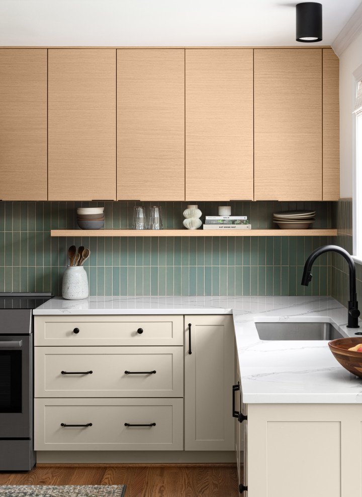 Design ideas for a small midcentury l-shaped eat-in kitchen in DC Metro with an undermount sink, flat-panel cabinets, light wood cabinets, quartz benchtops, green splashback, ceramic splashback, stainless steel appliances, medium hardwood floors, with island, brown floor and white benchtop.