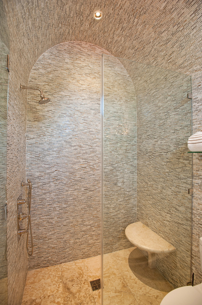 Design ideas for a mediterranean bathroom in Miami with an alcove shower, multi-coloured tile and matchstick tile.