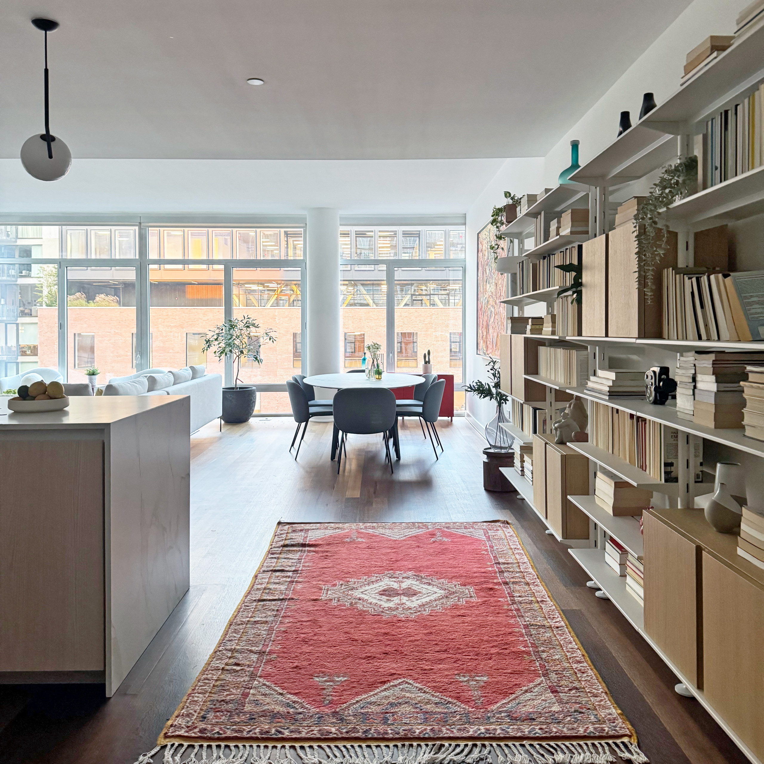 This stunning dining area is part of a beautifully designed open-concept space that feels bright, airy, and welcoming. Framed by floor-to-ceiling windows, the dining nook is bathed in natural light, m
