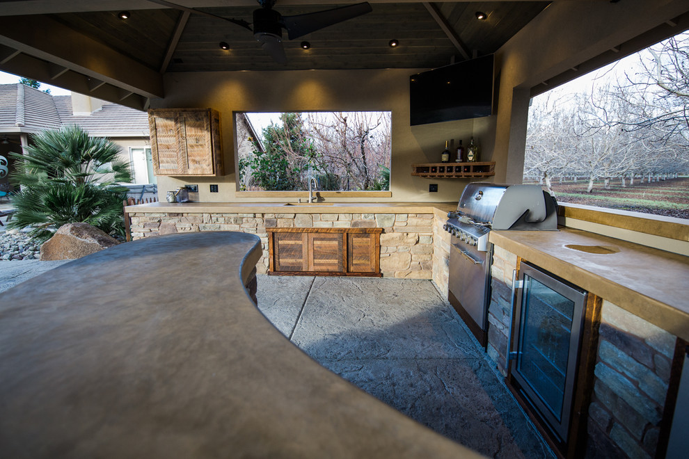 Large modern backyard patio in Other with an outdoor kitchen, a gazebo/cabana and stamped concrete.