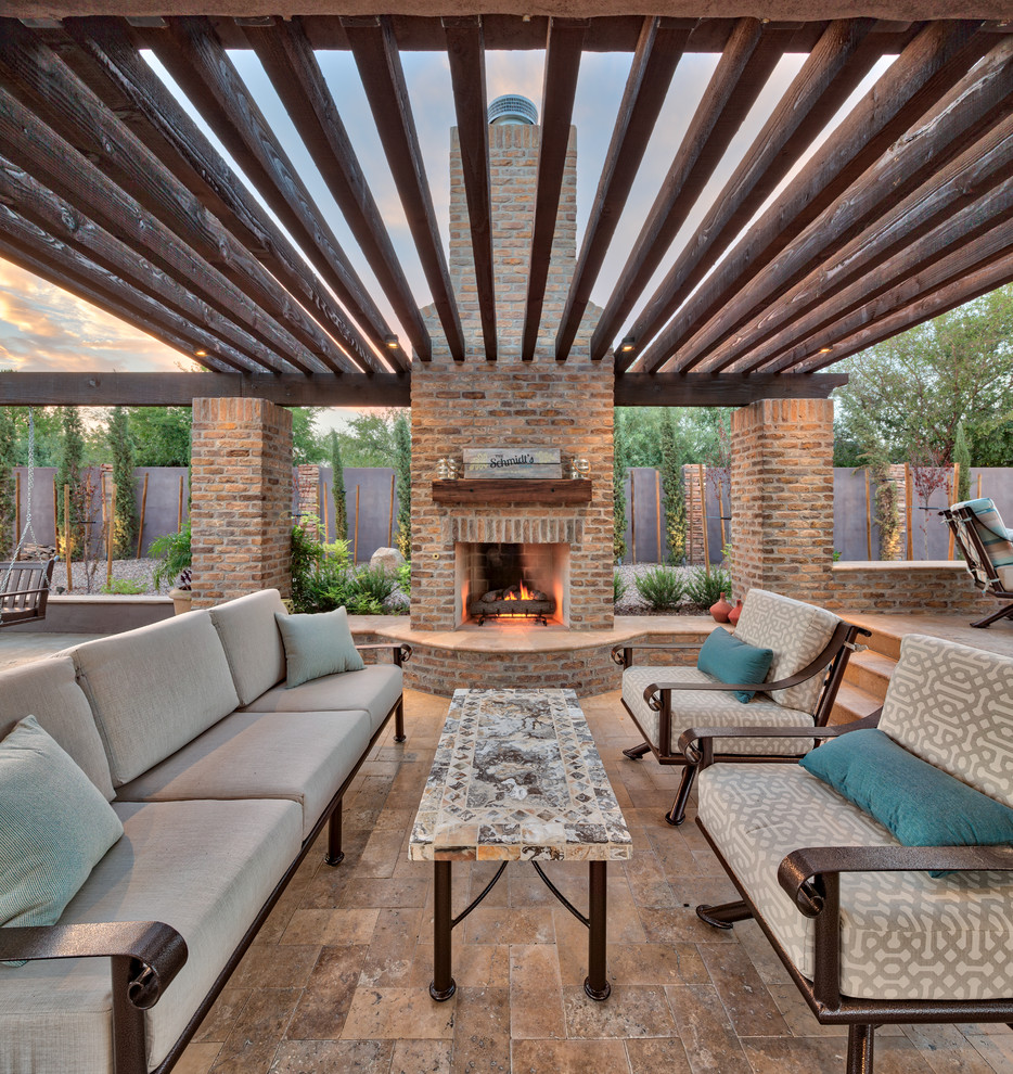 Large mediterranean backyard patio in Phoenix with natural stone pavers.