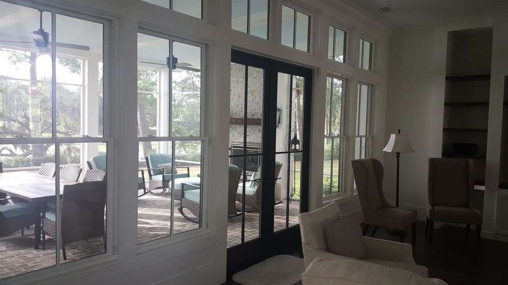 Mid-sized coastal open concept dark wood floor family room photo in San Diego with white walls and a media wall